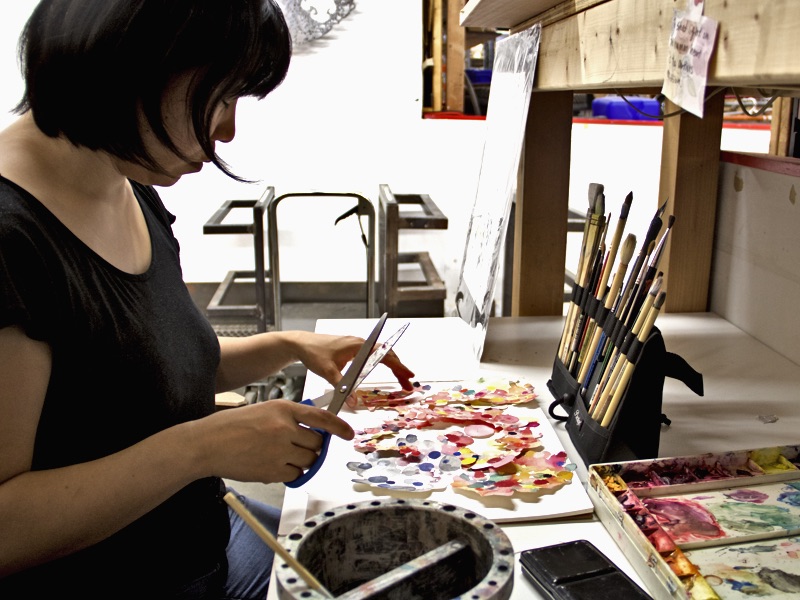 Chie painting in her art studio.